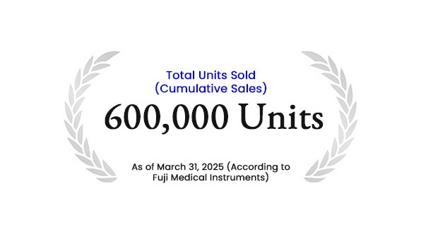 Milestone badge showing 600,000 units sold, framed by gray laurel leaves, as of March 31, 2025 (Fuji Medical Instruments).